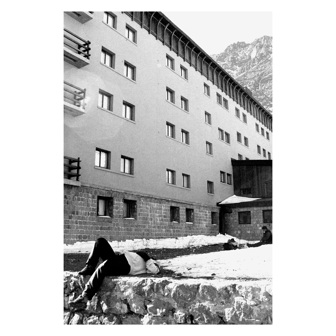 Man sleeping in the snow shot on Ilford Ortho Plus 80 with a Nikon F Photomic, by nichrogafilm