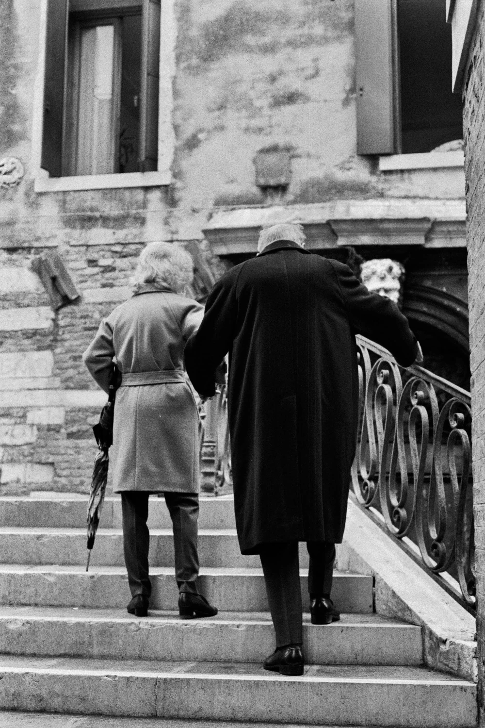 One step at a time, arm in arm: Love. shot on Ilford HP5 Plus 400 with a Canon T50, by Rebecca Abinti