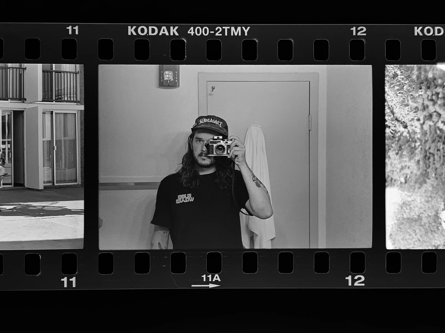 Phone previewing shot on Kodak T-Max 400 with a Nikon SP, by Squid
