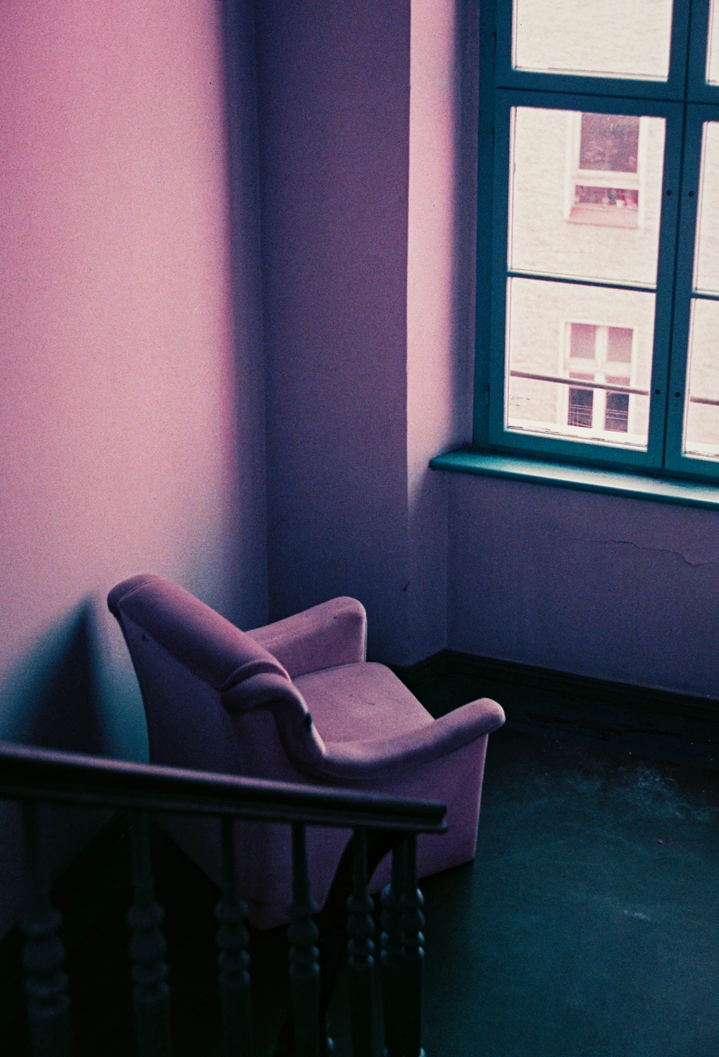 Skyblue sofa over a pink wall shot on Lomography LomoChrome Purple 100 with a Porst Compact Reflex SP, by Diego Osses